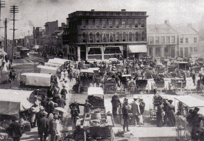 Market Square, crowded, looking north w/ Crown Bank of Canada visible